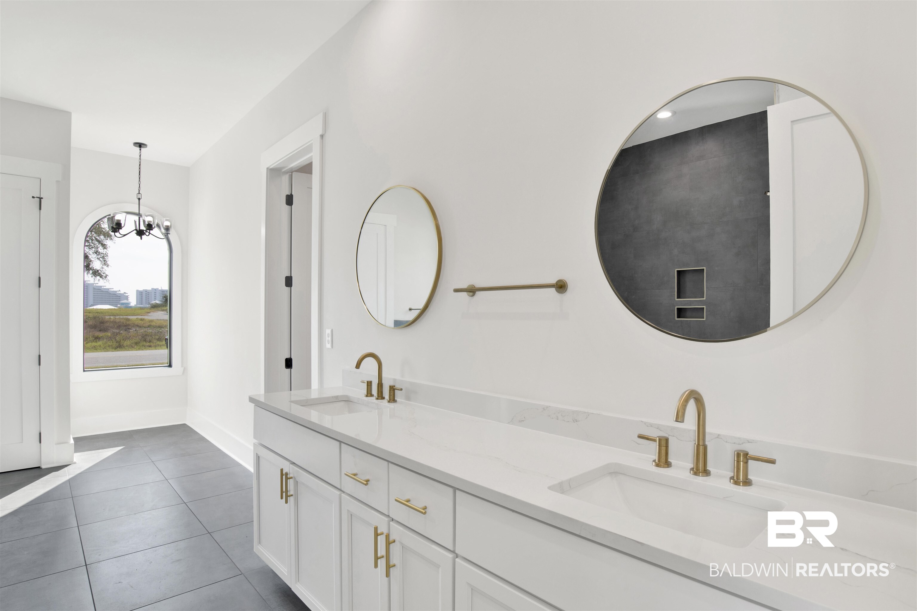31545 River Road Orange Beach, AL 36561 - Photo 9 of 59 Bathroom featuring a chandelier, vanity, and tile patterned flooring