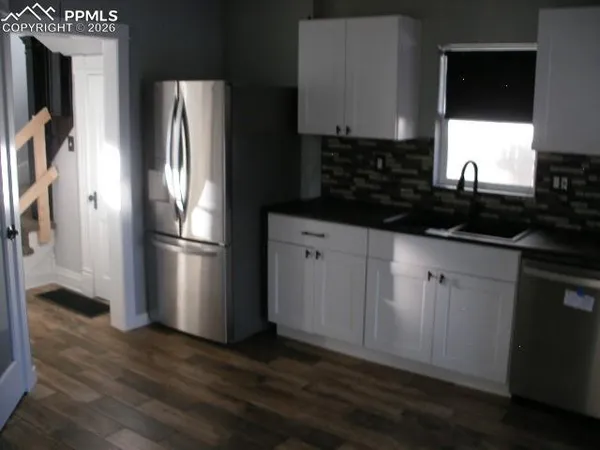 a kitchen with stainless steel appliances a refrigerator sink and stove