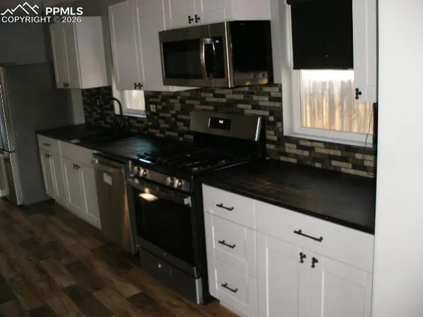 a kitchen with a sink stove and microwave