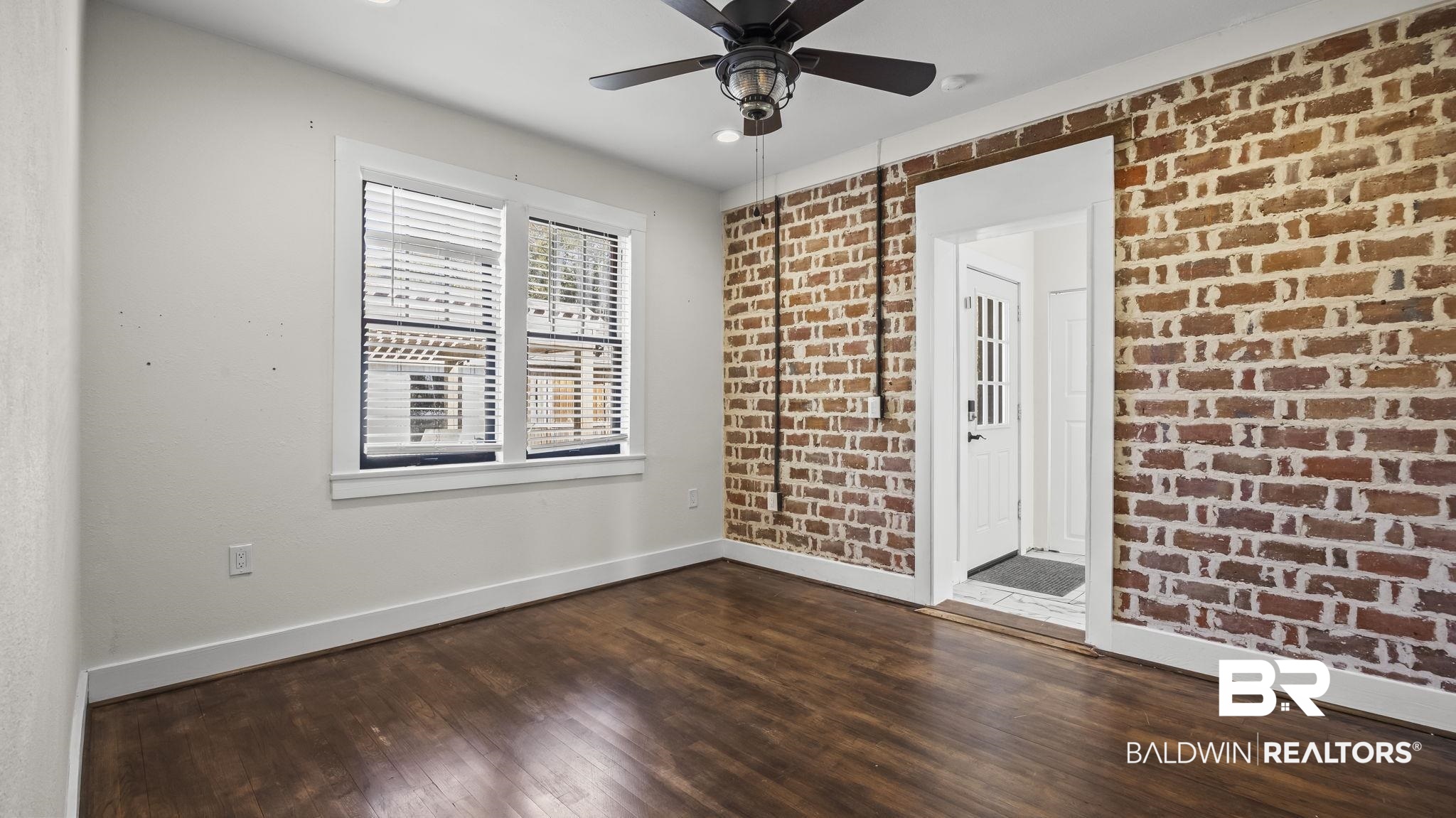 24701 Highway 98 Elberta, AL 36530 - Photo 14 of 32 Unfurnished room with dark wood-style flooring, brick wall, ceiling fan, and recessed lighting