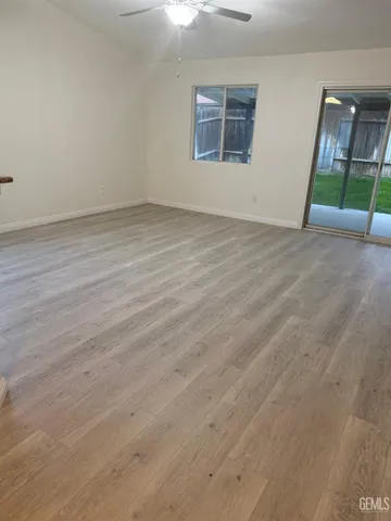an empty room with wooden floor and entrance