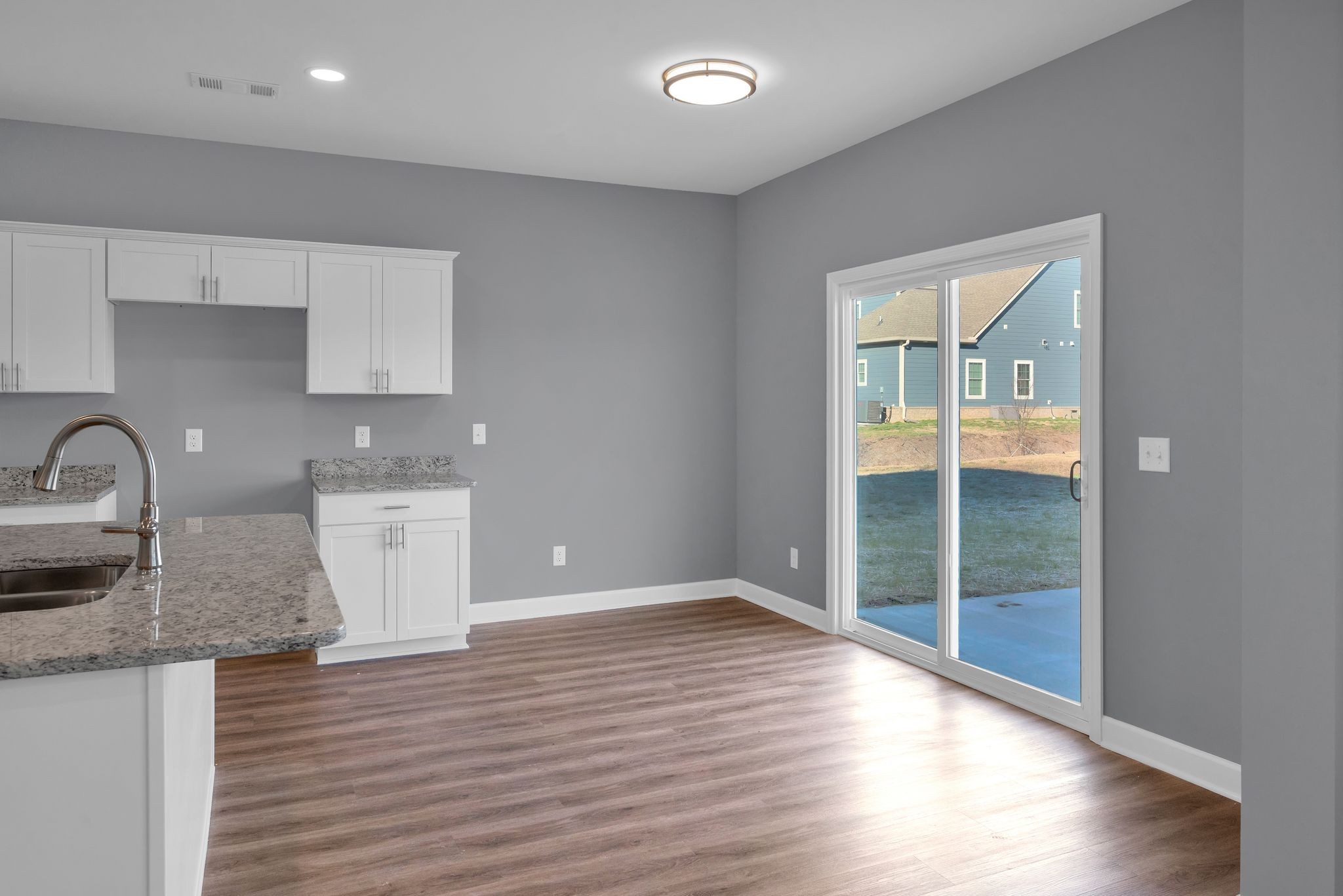 889 Blessing Way Gallatin, TN 37066 - Photo 12 of 37 a view of a kitchen with wooden floor and a sink