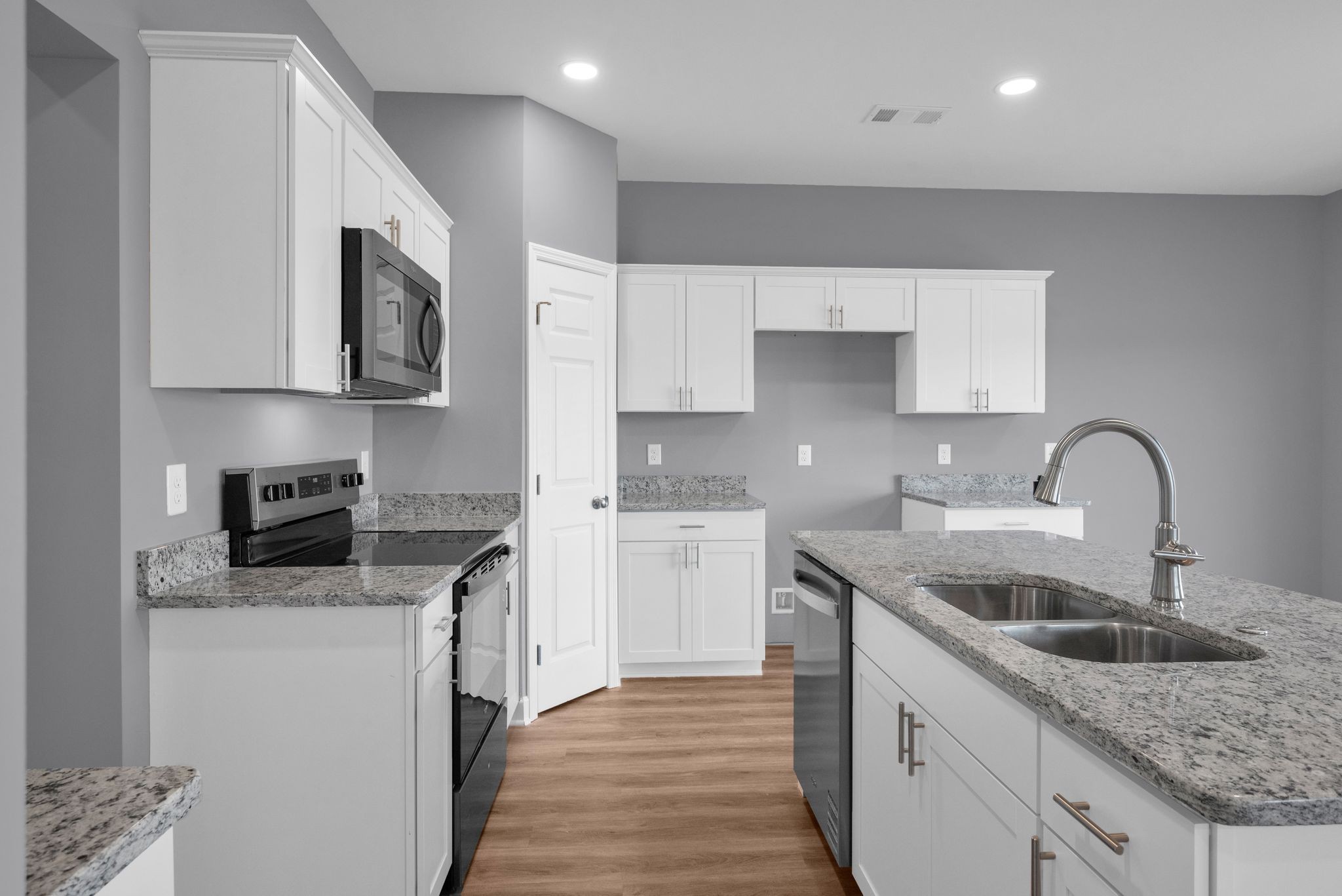 889 Blessing Way Gallatin, TN 37066 - Photo 16 of 37 a kitchen with stainless steel appliances granite countertop a sink stove top oven and refrigerator