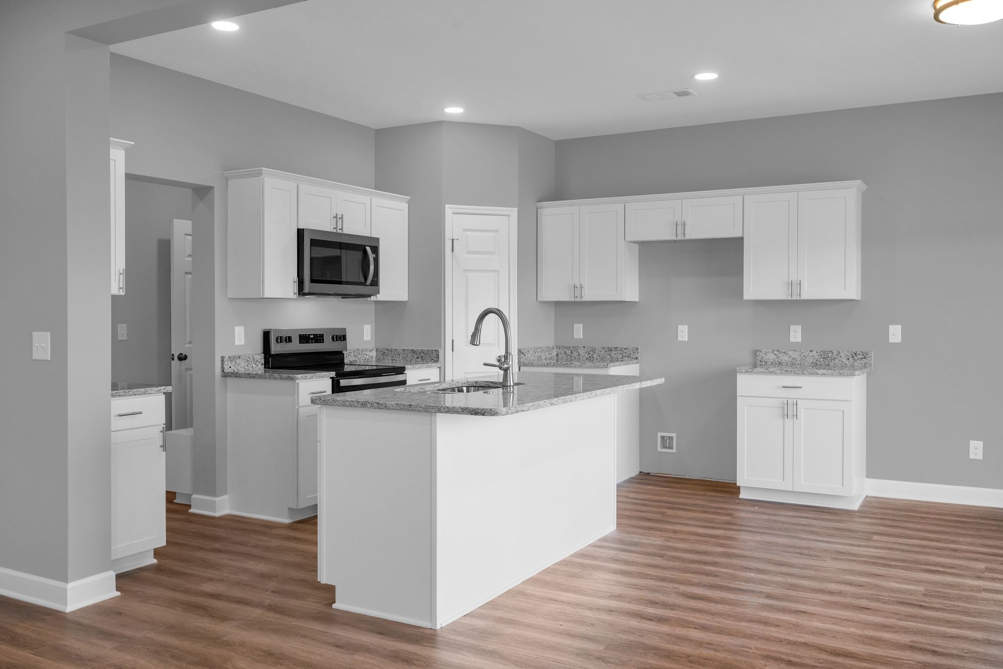 889 Blessing Way Gallatin, TN 37066 - Photo 17 of 37 a kitchen with stainless steel appliances granite countertop a sink a stove a refrigerator and cabinets