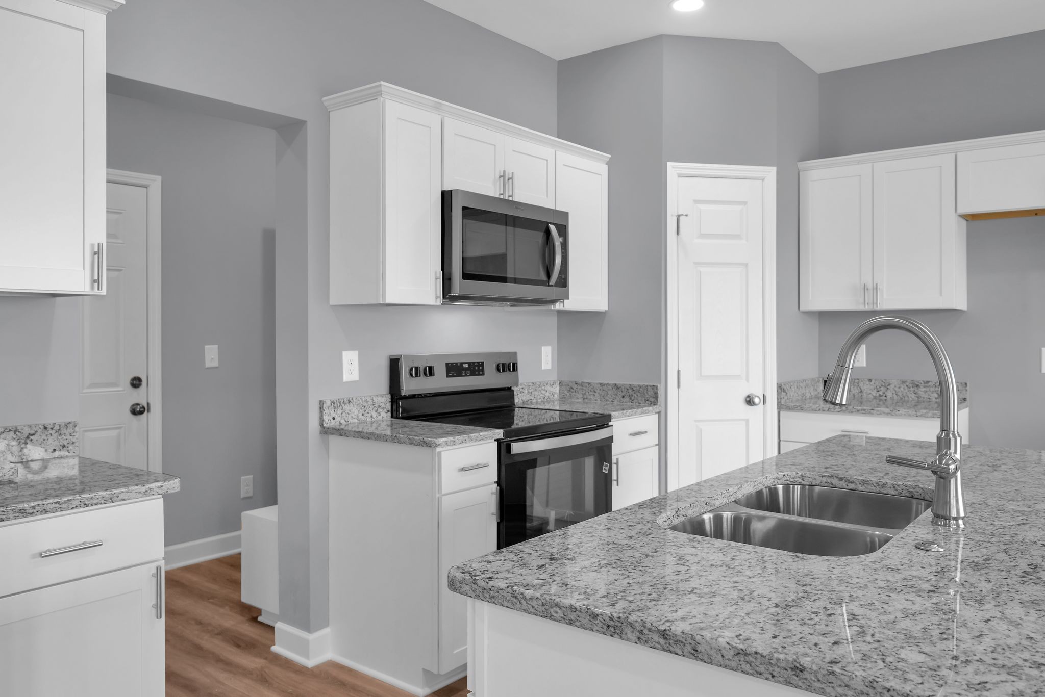 889 Blessing Way Gallatin, TN 37066 - Photo 18 of 37 a kitchen with granite countertop a sink and stainless steel appliances