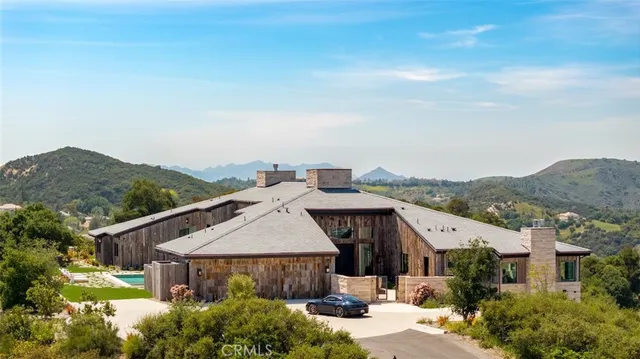 an aerial view of a house with a yard and balcony