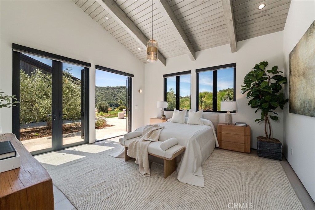 3121 Old Topanga Canyon Road Calabasas, CA 91302 - Photo 23 of 75 a bed sitting in a spacious bedroom next to a large window
