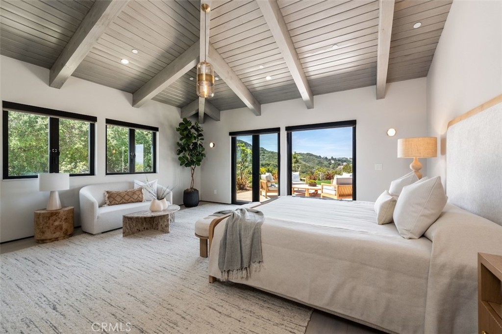 3121 Old Topanga Canyon Road Calabasas, CA 91302 - Photo 37 of 75 a bedroom with a large bed and a large window