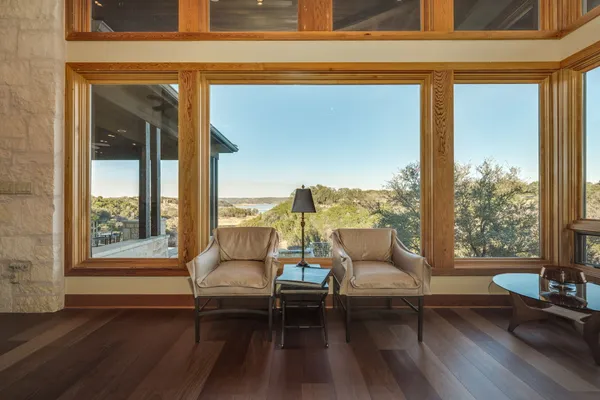 a living room with furniture and floor to ceiling windows