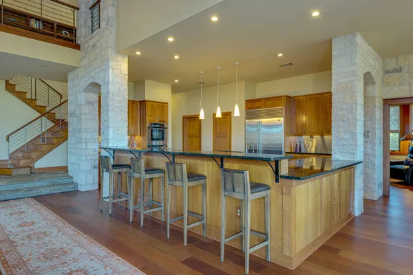 a very nice looking dining room with wooden floor and windows