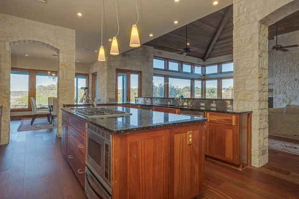 a kitchen with stainless steel appliances granite countertop a stove and a kitchen island