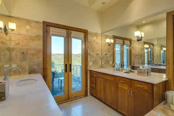 a bathroom with a double vanity sink toilet and shower