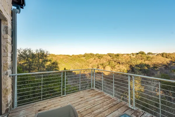 a view of a balcony with wooden floor