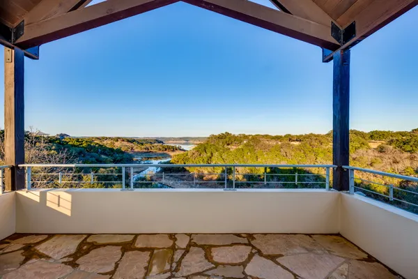 a view of a porch with furniture and a yard