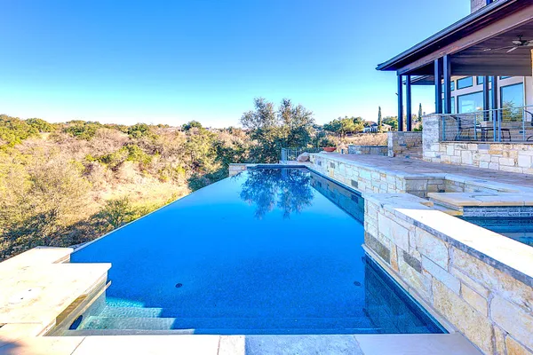 a view of a house with a yard and a patio