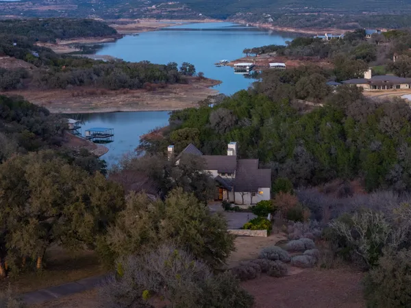 an aerial view of a house a yard and mountain view
