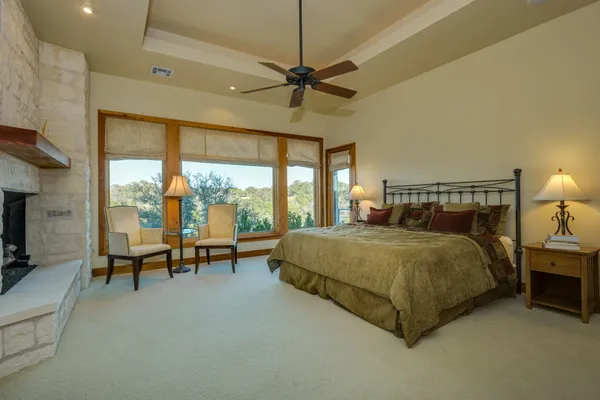 a spacious bedroom with a bed and a chandelier