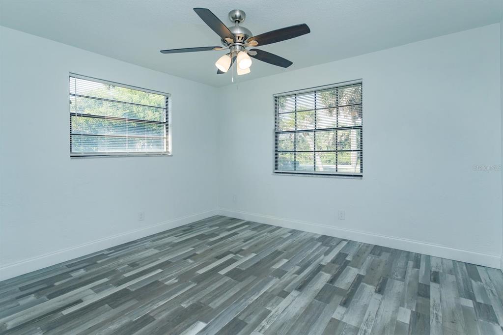 4319 South Peninsula Drive Ponce Inlet, FL 32127 - Photo 19 of 25 wooden floor in an empty room with a window