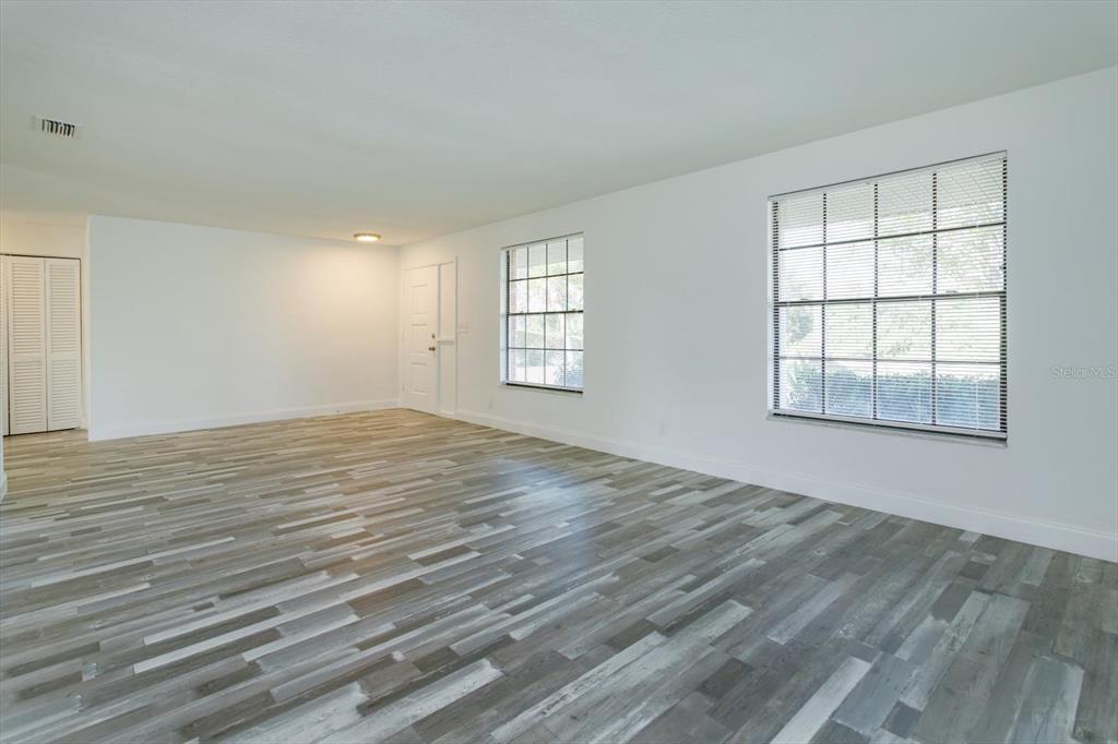 4319 South Peninsula Drive Ponce Inlet, FL 32127 - Photo 5 of 25 an empty room with wooden floor and windows