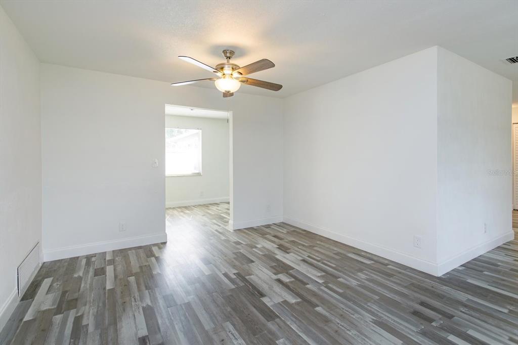 4319 South Peninsula Drive Ponce Inlet, FL 32127 - Photo 6 of 25 a view of an empty room with wooden floor and a window