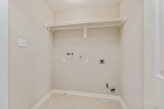 an empty room with a chandelier fan and a ceiling fan