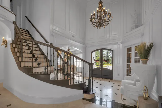 a living room with furniture a fireplace and a potted plant