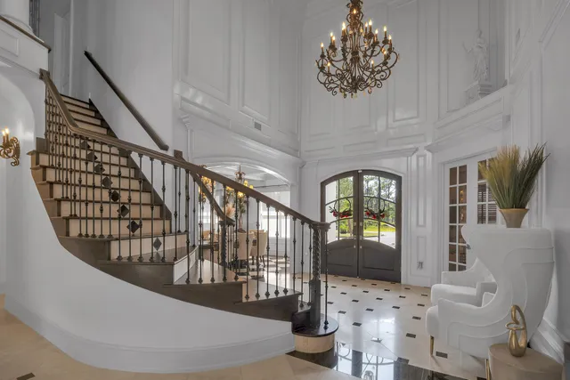 a living room with furniture and a chandelier