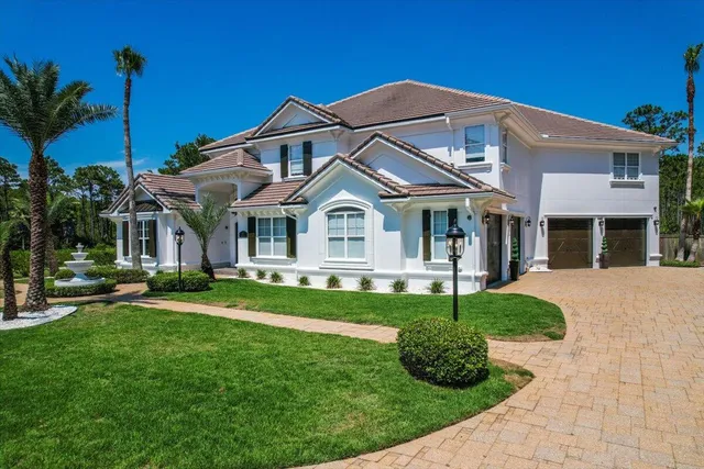 a front view of a house with a garden and porch