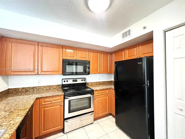 a kitchen with a refrigerator stove and microwave
