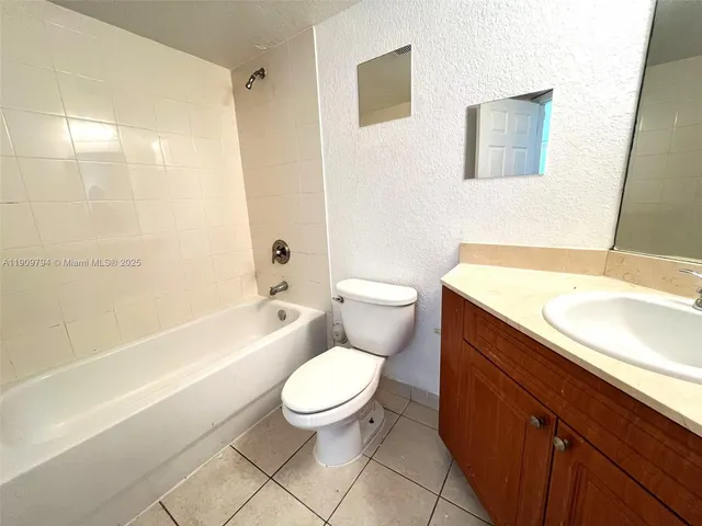 a bathroom with a sink a toilet and bathtub