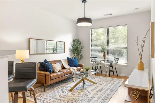 a living room with furniture a table and a potted plant