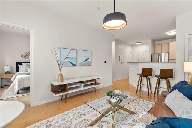 a living room with furniture and a wooden floor