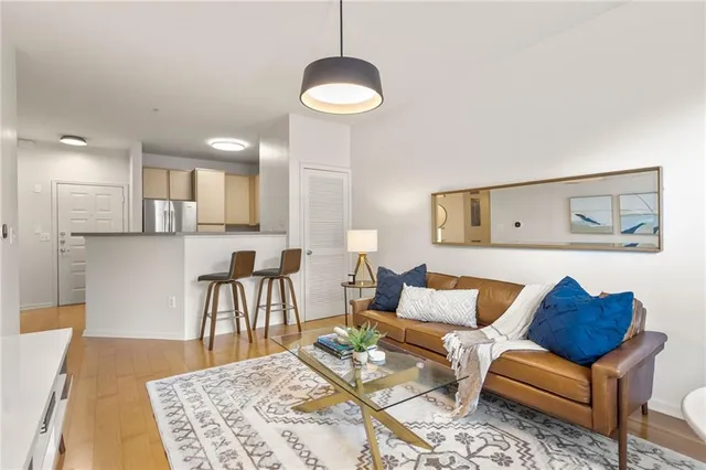 a living room with furniture and a wooden floor
