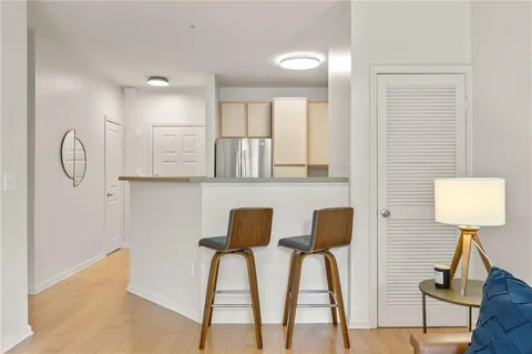 a lamp on a table and a chair in a room