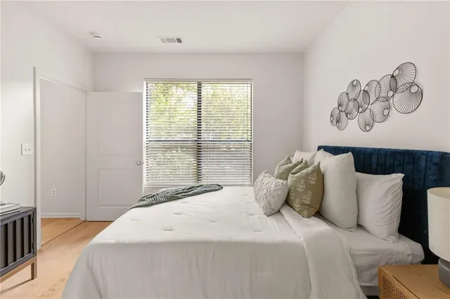 a bedroom with a bed and a window