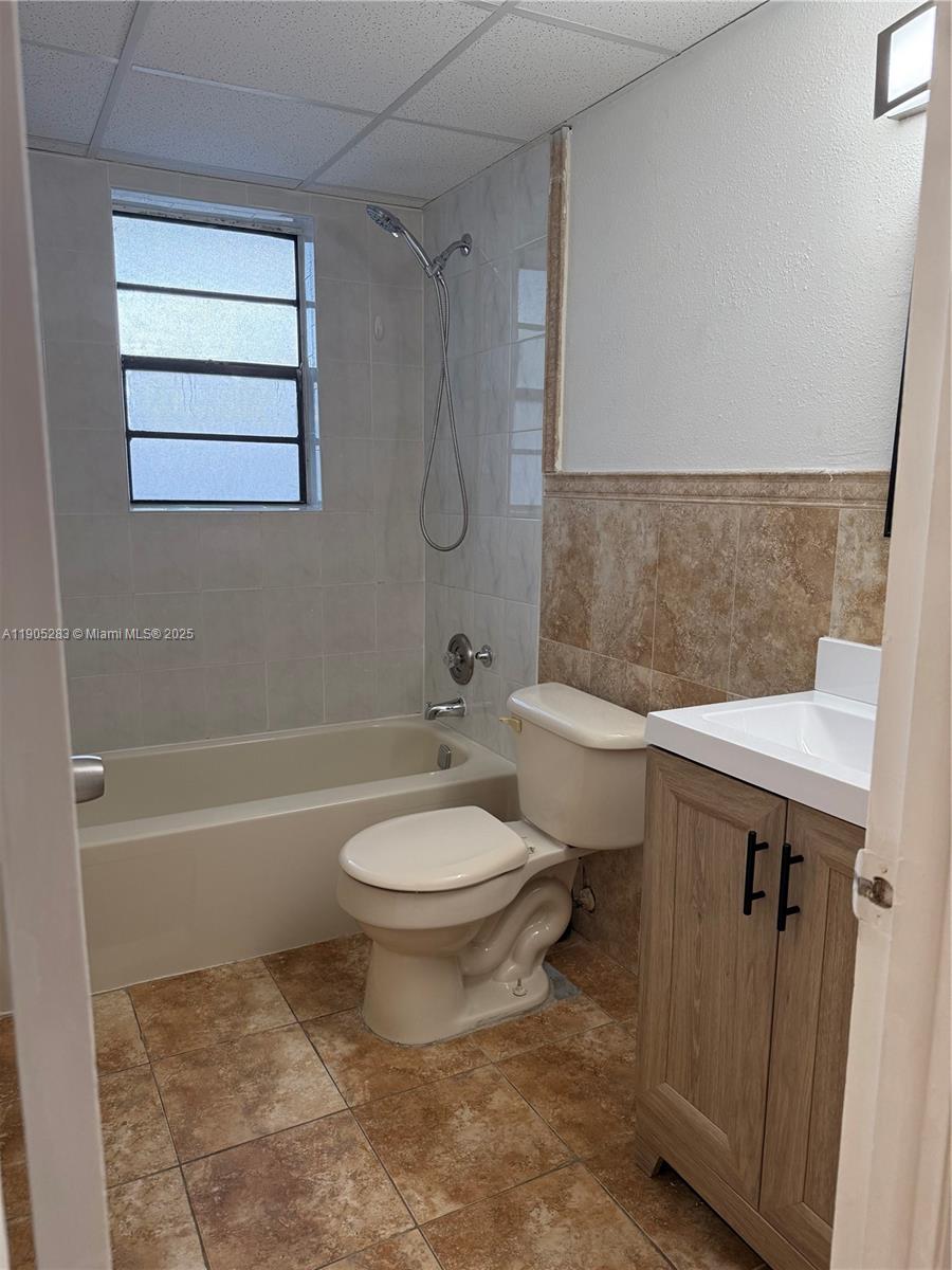 9460 Fontainebleau Boulevard, Unit 331 Miami, FL 33172 - Photo 11 of 17 a bathroom with a sink a toilet and shower