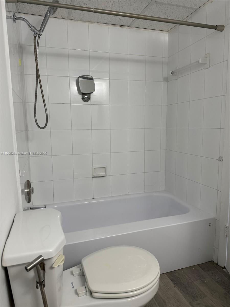 9460 Fontainebleau Boulevard, Unit 331 Miami, FL 33172 - Photo 13 of 17 a bathroom with a toilet bathtub and shower