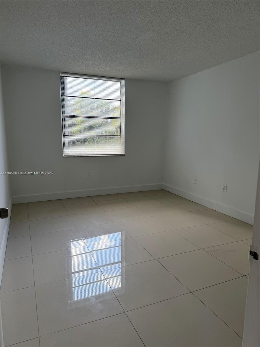 9460 Fontainebleau Boulevard, Unit 331 Miami, FL 33172 - Photo 6 of 17 an empty room with windows