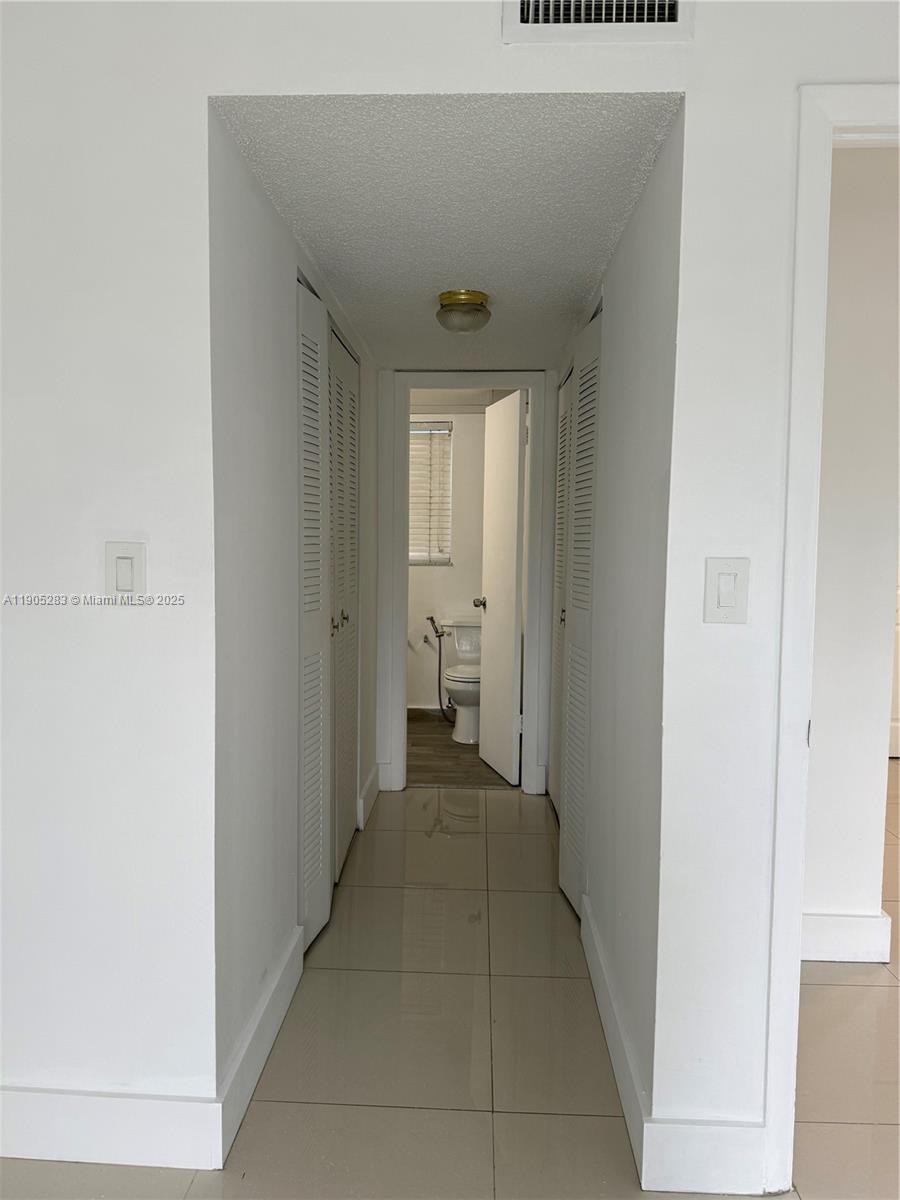 9460 Fontainebleau Boulevard, Unit 331 Miami, FL 33172 - Photo 7 of 17 a view of a hallway in a house