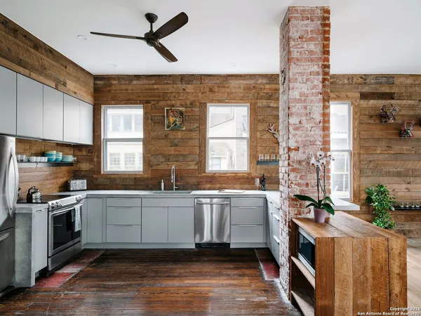 a kitchen with a sink stove and cabinets