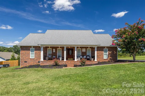 a view of a house with a yard porch and sitting area