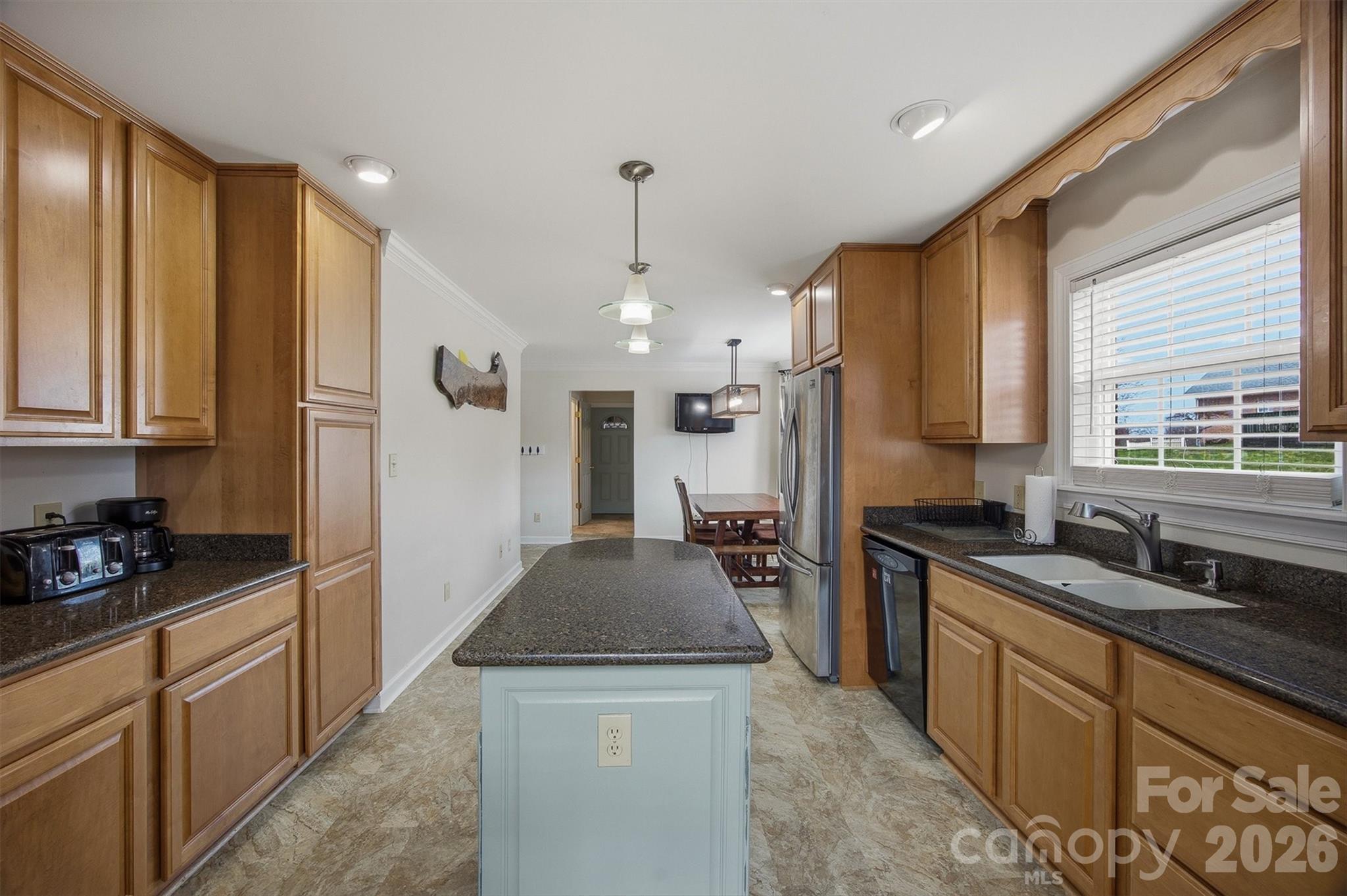 2553 Genes Loop Morganton, NC 28655 - Photo 14 of 32 a kitchen with stainless steel appliances granite countertop a sink stove and refrigerator