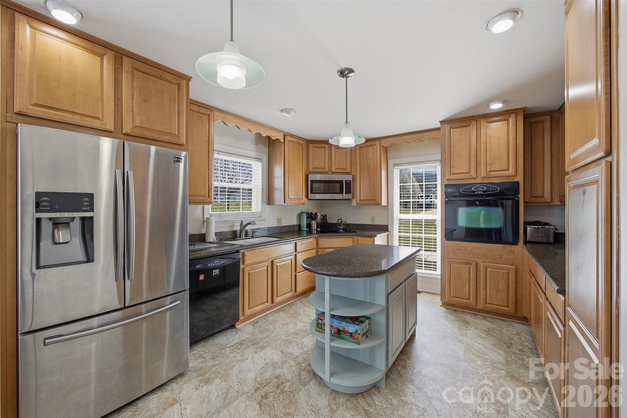 2553 Genes Loop Morganton, NC 28655 - Photo 15 of 32 a kitchen with stainless steel appliances granite countertop a refrigerator a stove a sink and a refrigerator