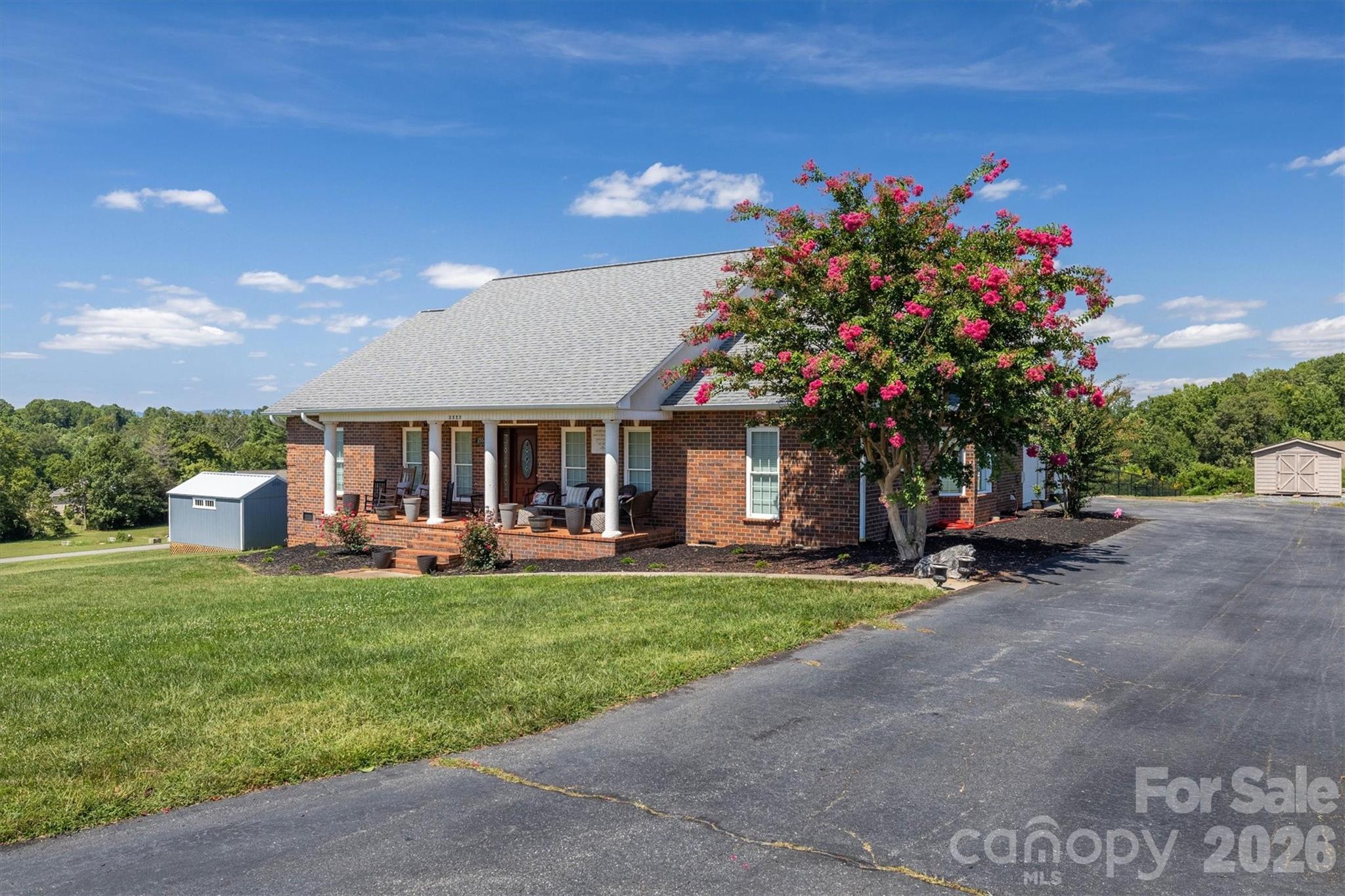 2553 Genes Loop Morganton, NC 28655 - Photo 2 of 32 a front view of a house with a garden and sitting area