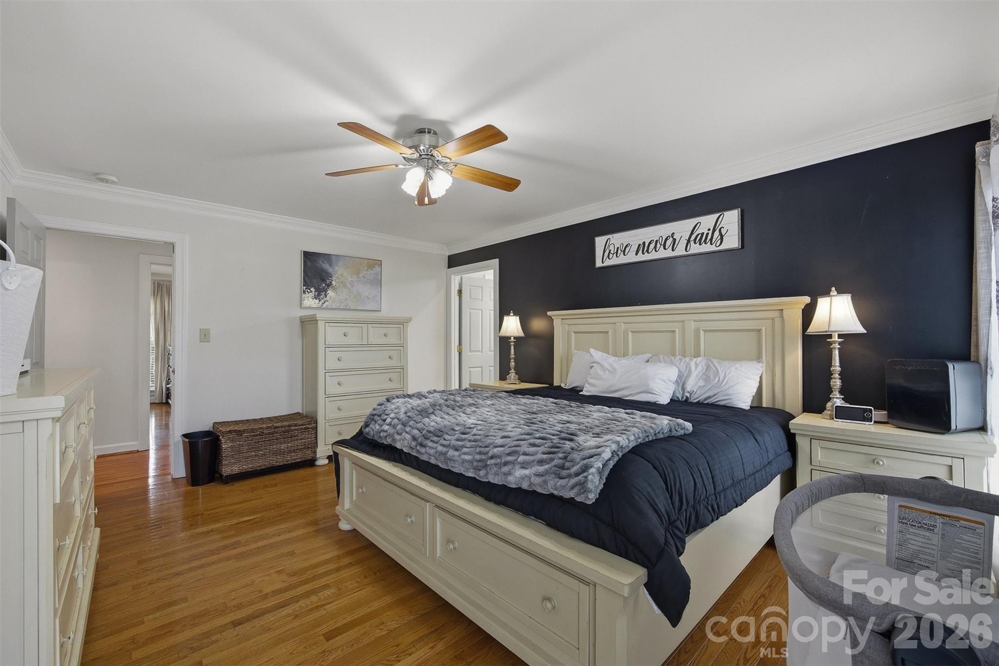2553 Genes Loop Morganton, NC 28655 - Photo 23 of 32 a bedroom with a bed and a chandelier