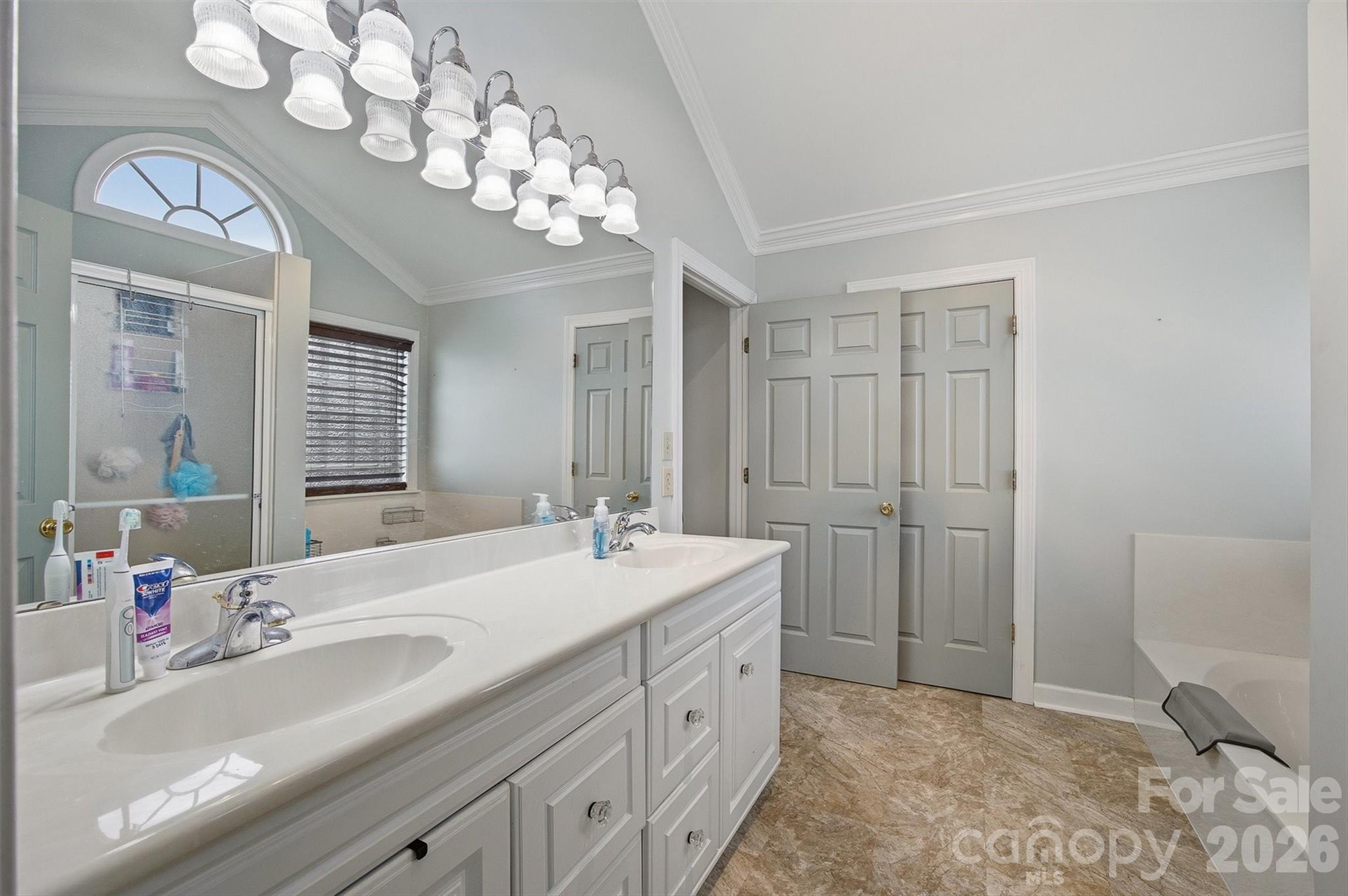 2553 Genes Loop Morganton, NC 28655 - Photo 25 of 32 a spacious bathroom with a sink a large mirror and a shower