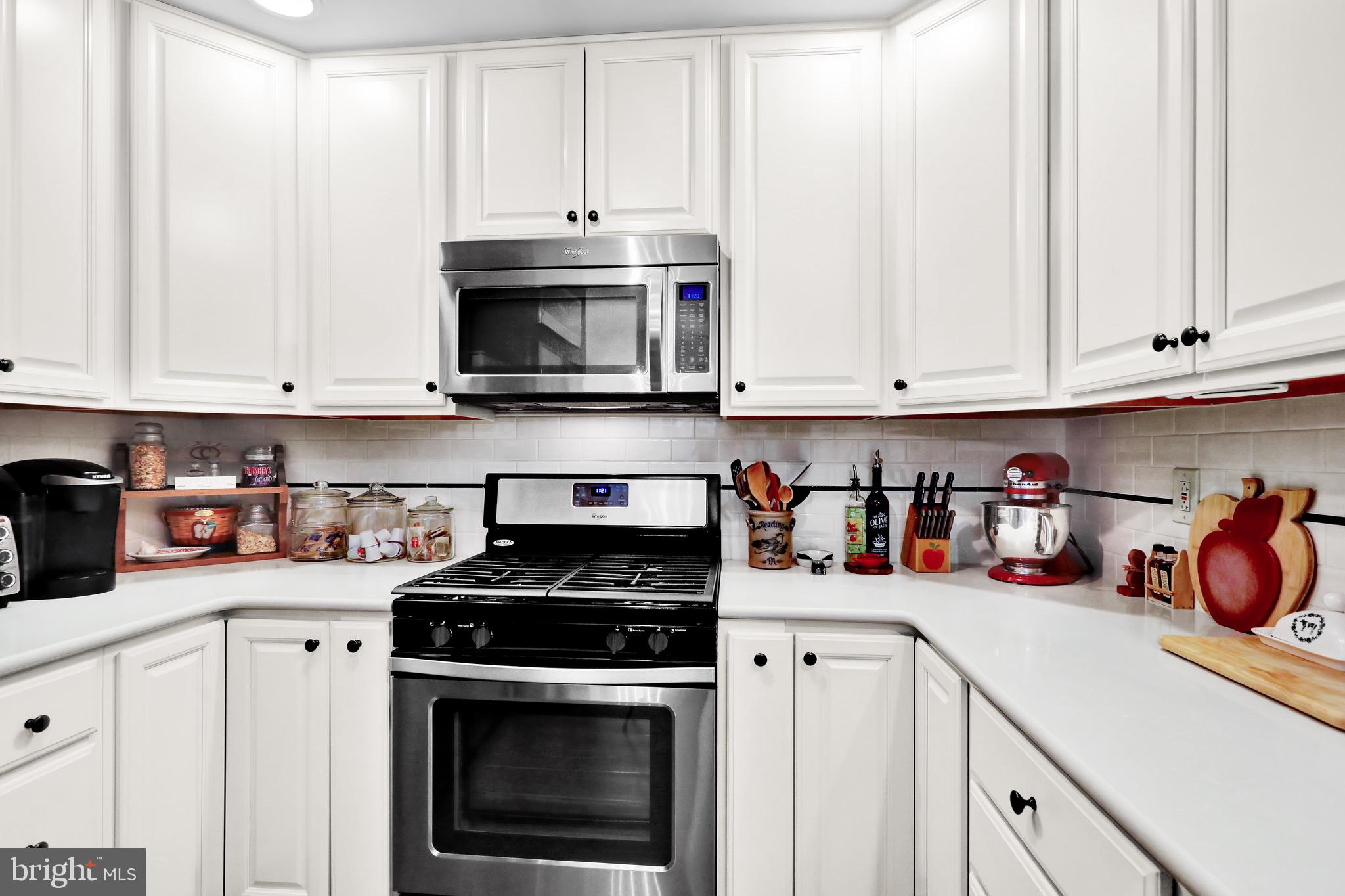 237 North 14th Street Reading, PA 19604 - Photo 11 of 26 a kitchen with stainless steel appliances granite countertop a stove a white cabinets and a refrigerator