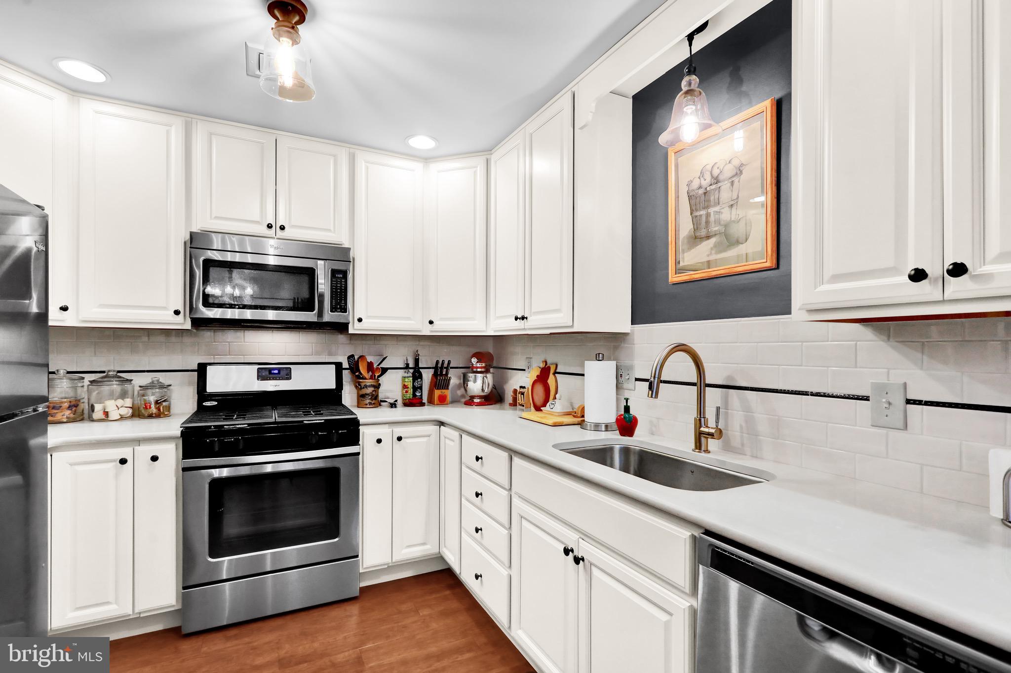 237 North 14th Street Reading, PA 19604 - Photo 12 of 26 a kitchen with stainless steel appliances granite countertop a stove a sink and a microwave