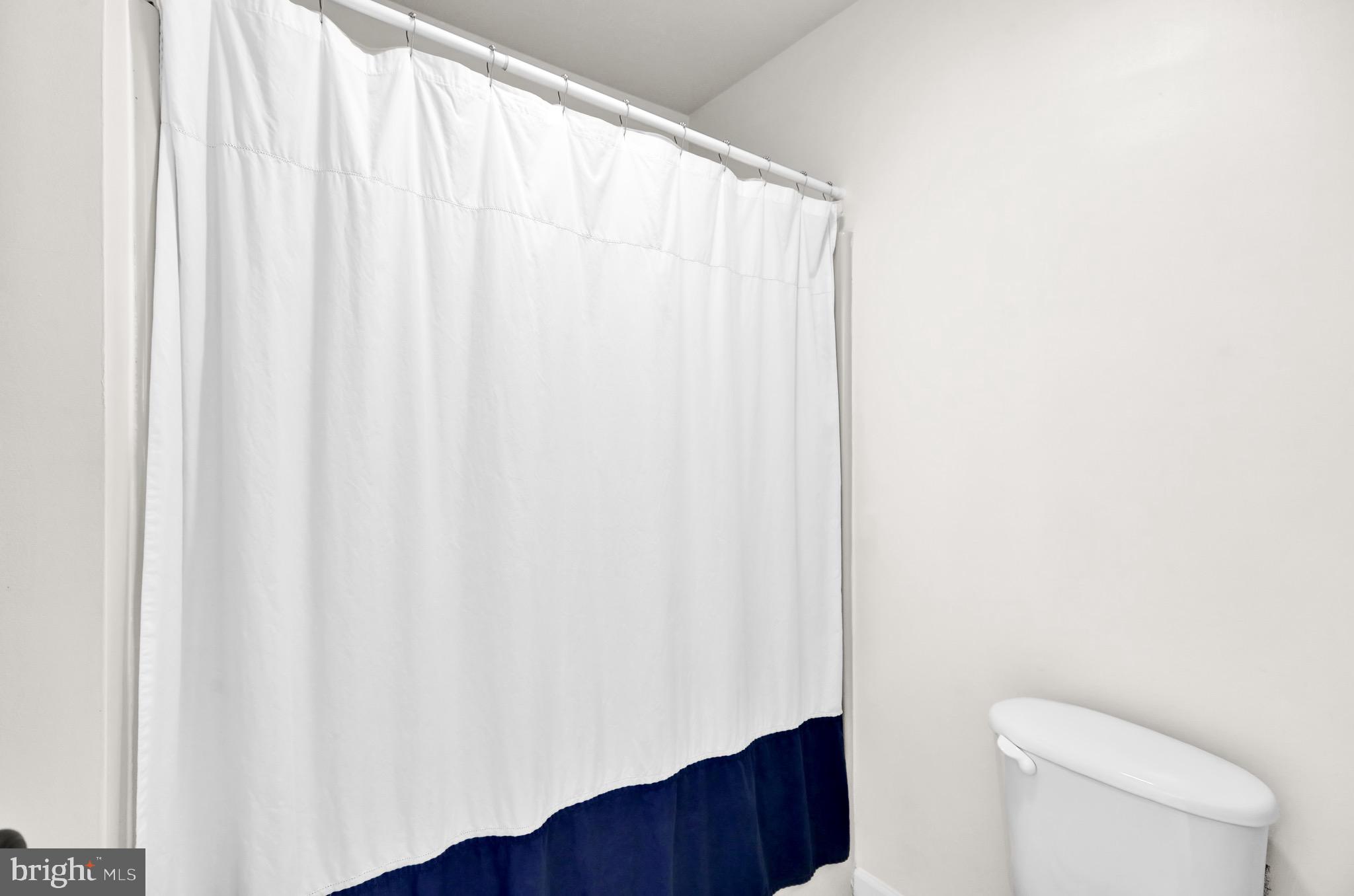 237 North 14th Street Reading, PA 19604 - Photo 19 of 26 a bathroom with a shower curtain and toilet