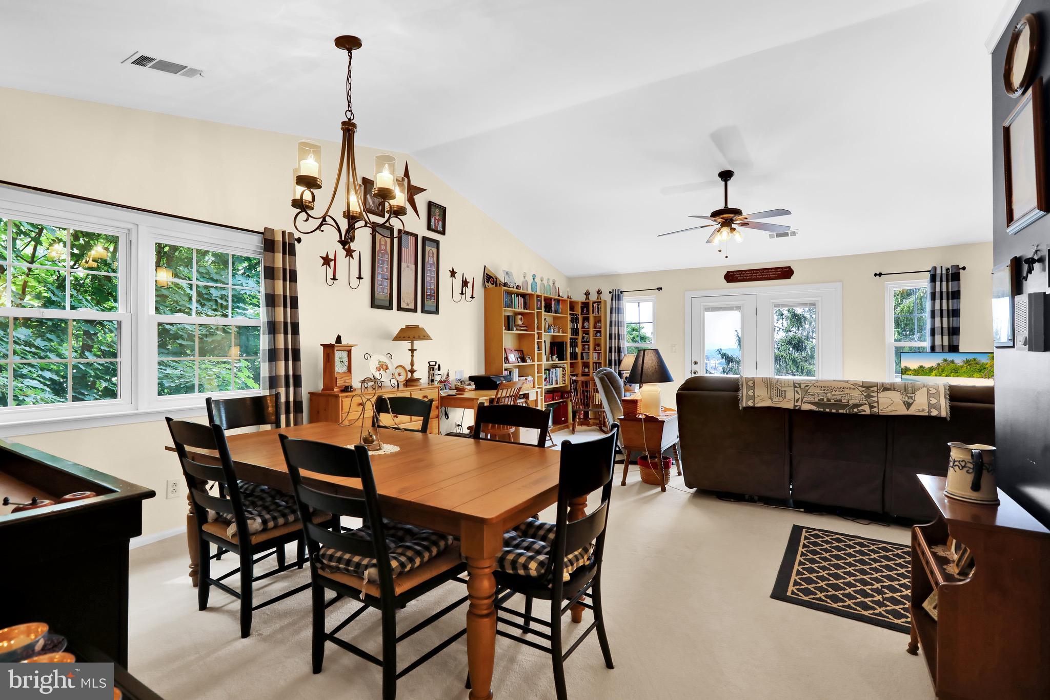 237 North 14th Street Reading, PA 19604 - Photo 8 of 26 a dining room with wooden floor a chandelier a wooden table and chairs